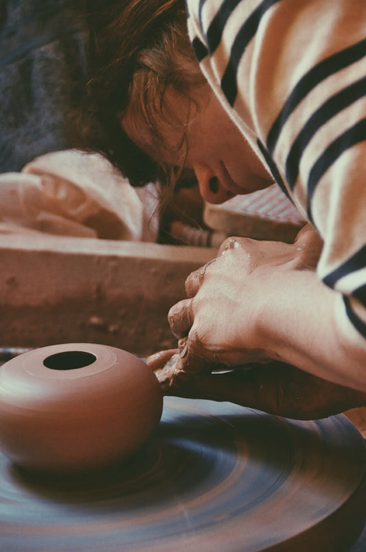 Cade at the potter's wheel