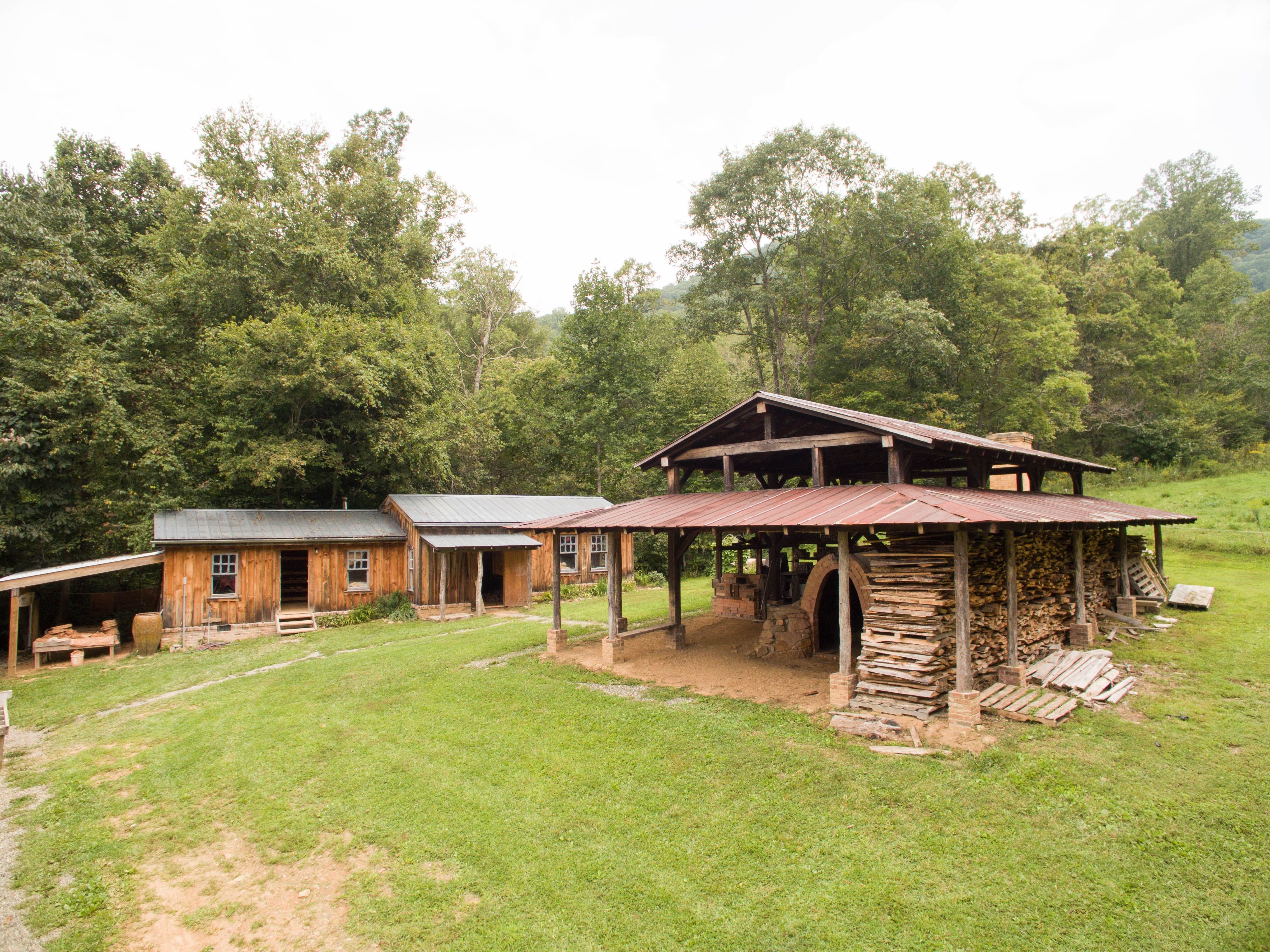East Fork's original wood kiln under the kiln shed with the workshop building in the background