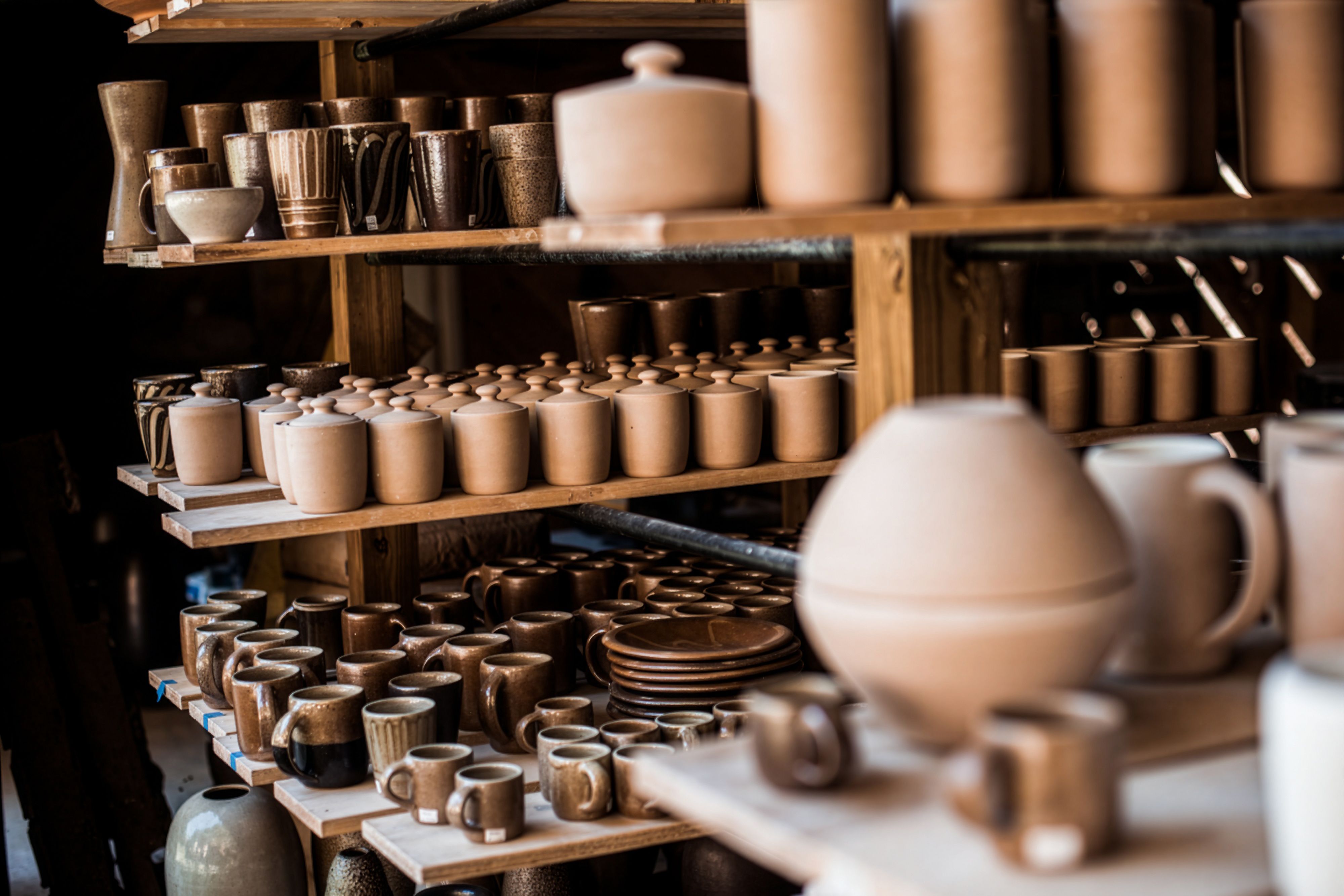 Freshly fired clay pots sit on shelves